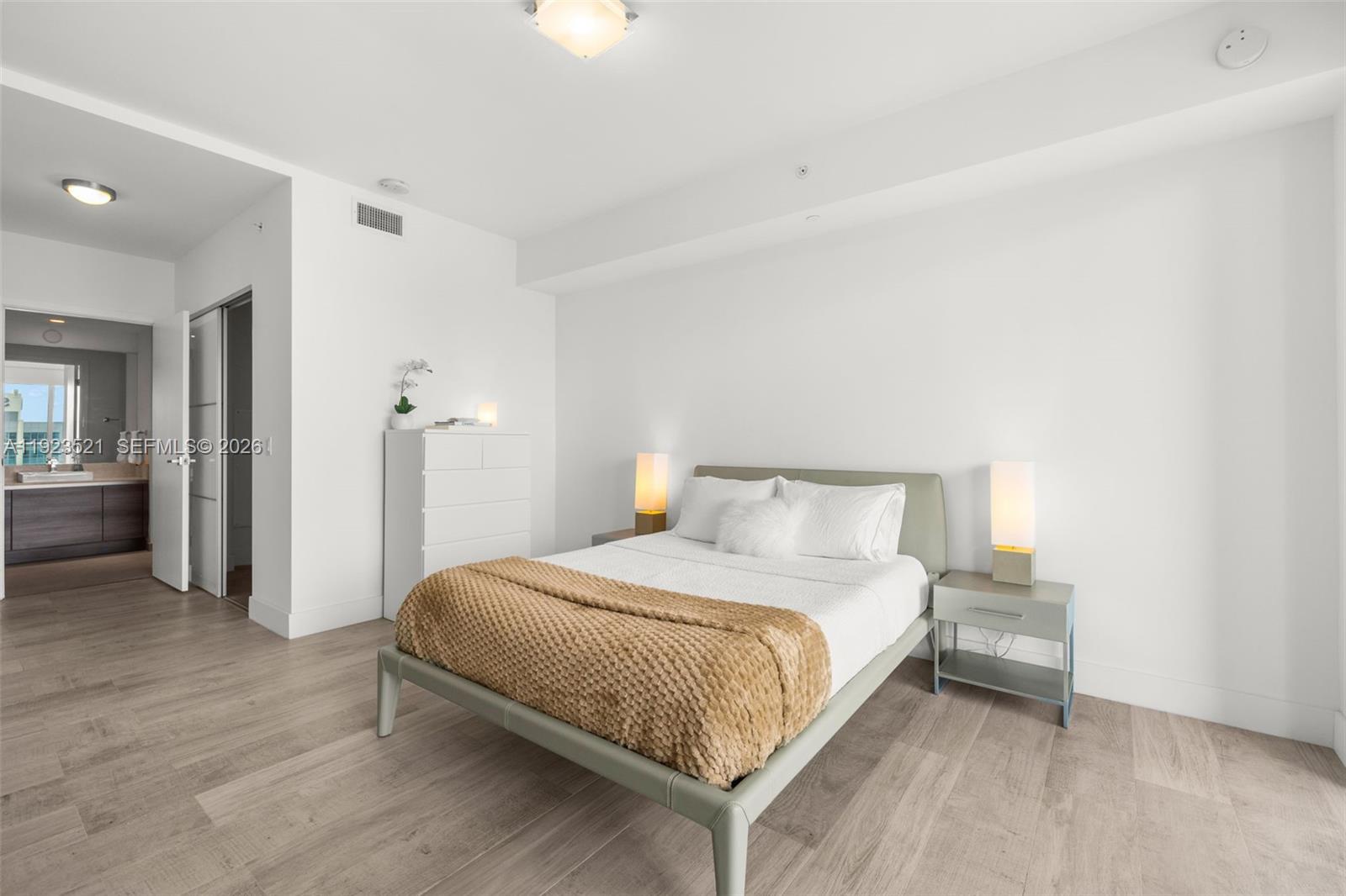 1080 Brickell Avenue, Unit 3602 Miami, FL 33131 - Photo 26 of 45 a bedroom with a bed and a lamp