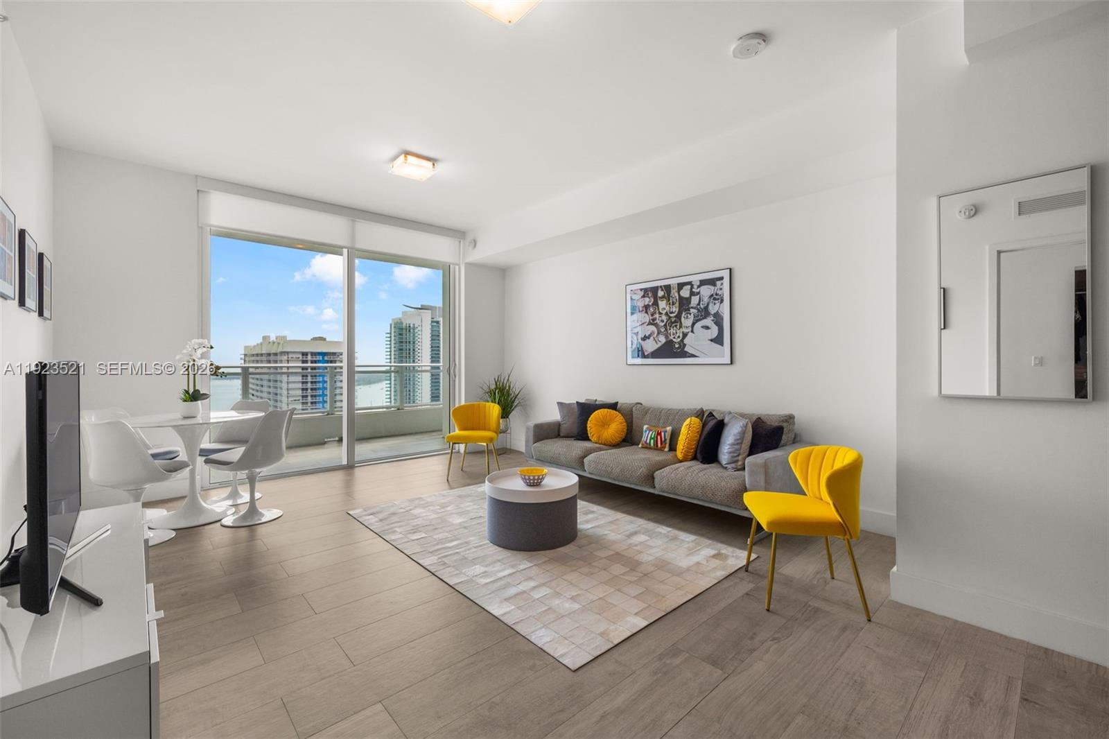1080 Brickell Avenue, Unit 3602 Miami, FL 33131 - Photo 3 of 45 a living room with furniture and a flat screen tv