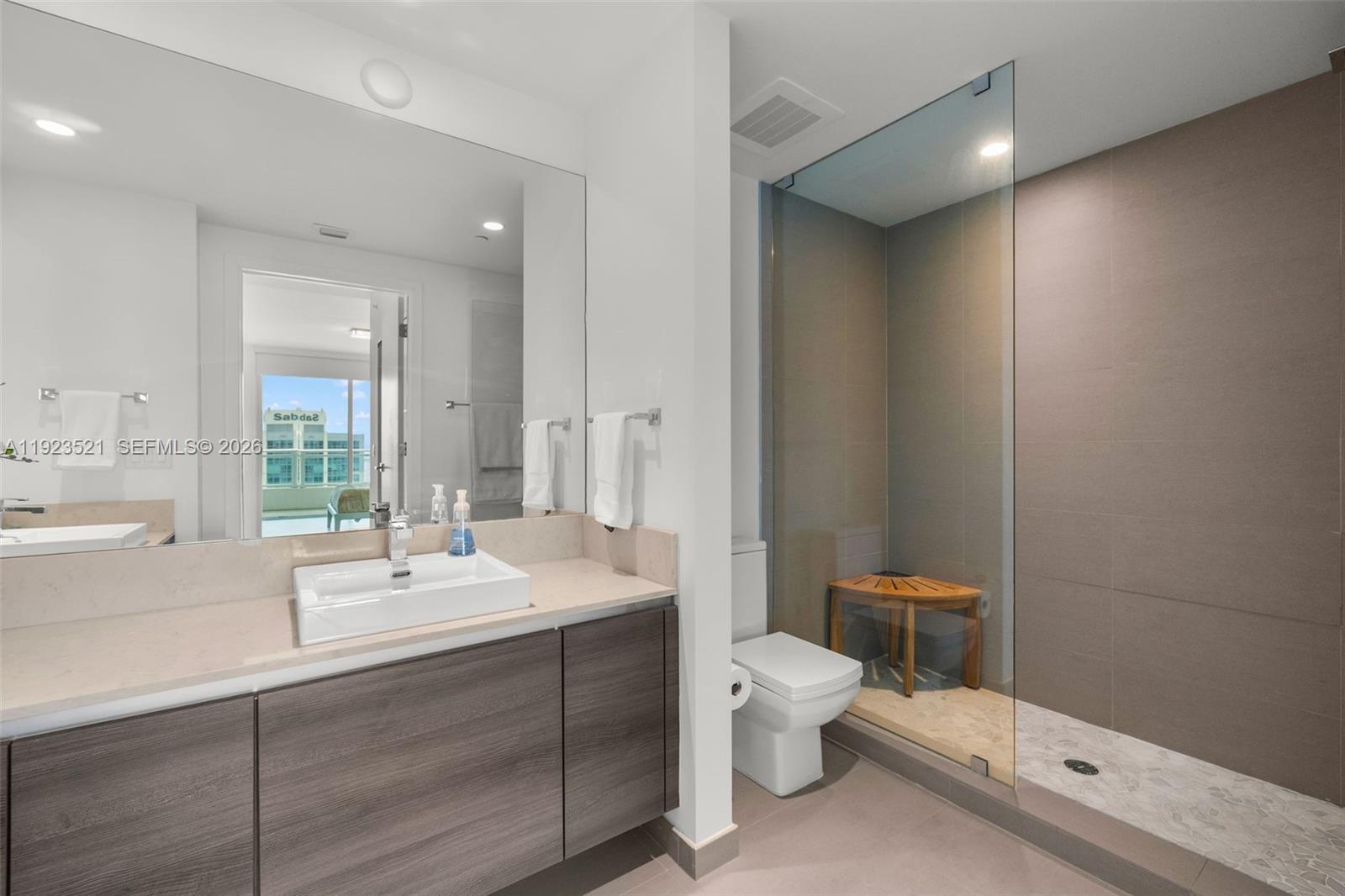 1080 Brickell Avenue, Unit 3602 Miami, FL 33131 - Photo 31 of 45 a bathroom with a double vanity sink toilet and mirror