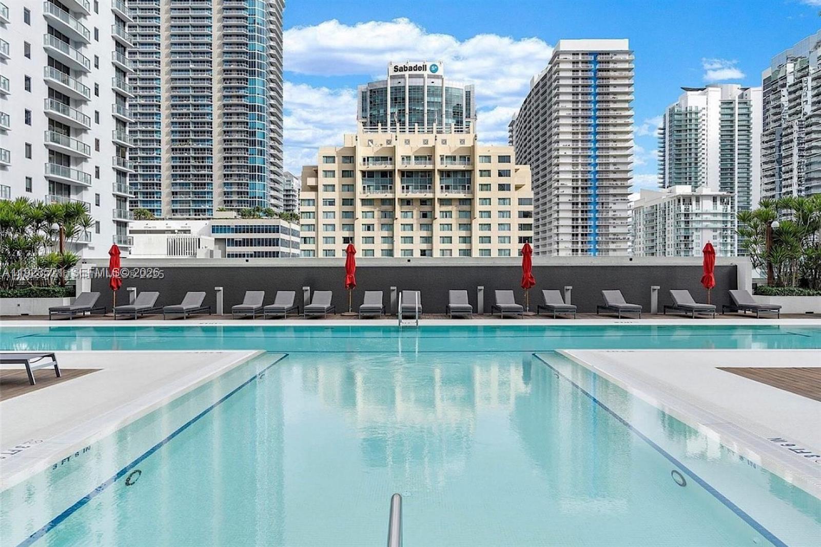 1080 Brickell Avenue, Unit 3602 Miami, FL 33131 - Photo 37 of 45 a swimming pool with outdoor seating and yard