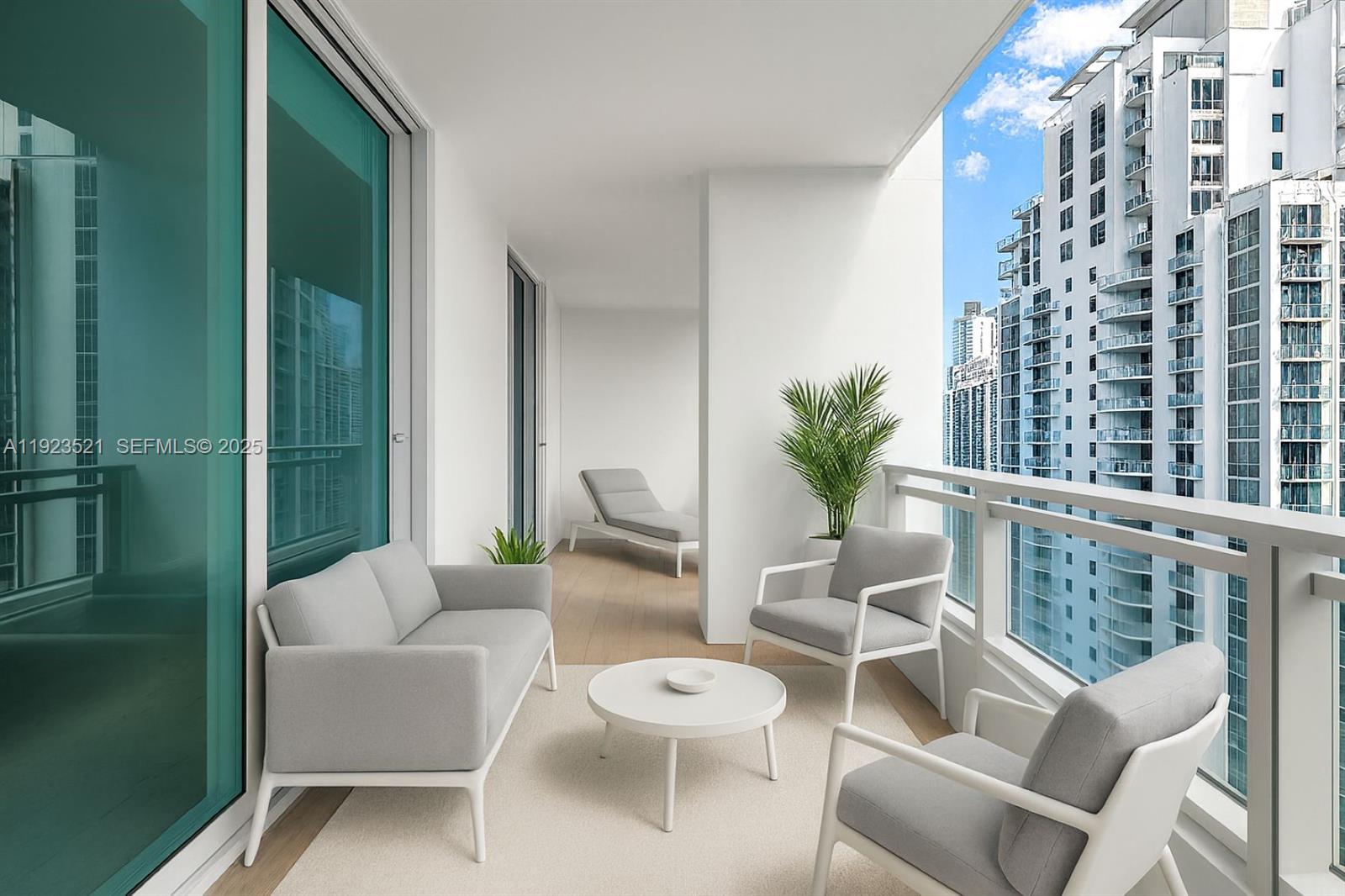 1080 Brickell Avenue, Unit 3602 Miami, FL 33131 - Photo 8 of 45 a view of a balcony with chairs and a potted plant