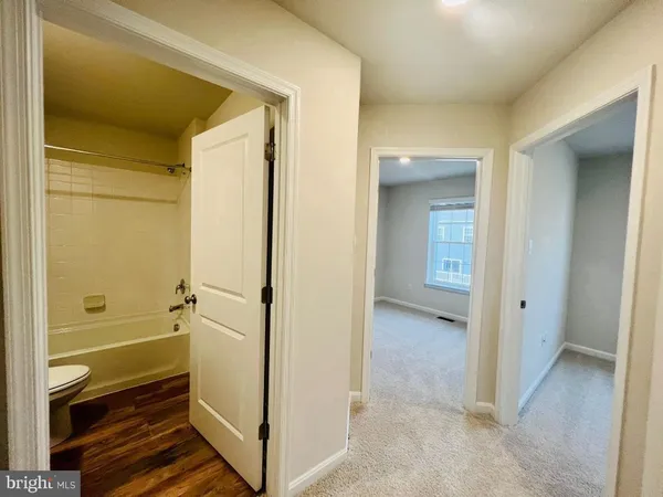 a view of bathroom with a tub shower and a sink