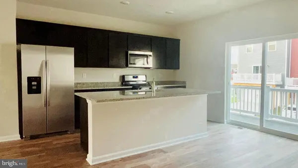 a kitchen with a refrigerator and a sink
