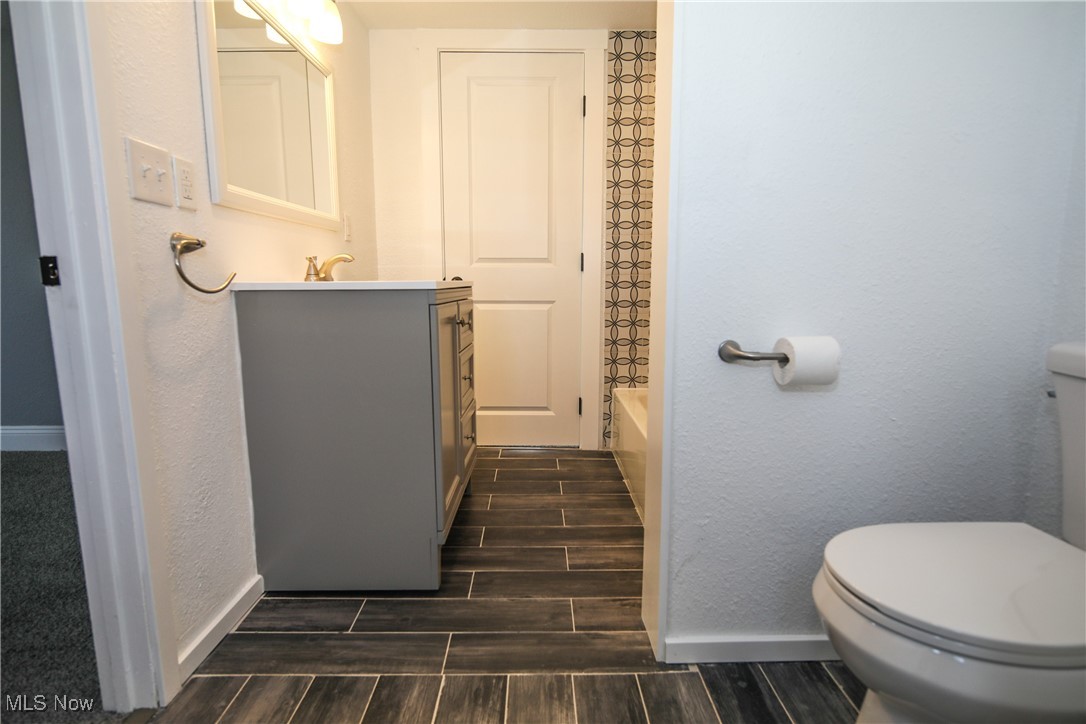 67480 Barnesville Hendrysburg Road Barnesville, OH 43713 - Photo 12 of 16 Full bathroom featuring vanity, toilet, and tub / shower combination