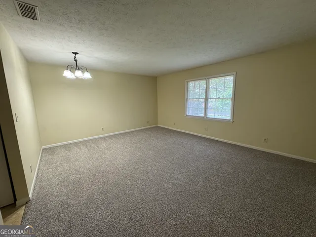 an empty room with a window and a fireplace