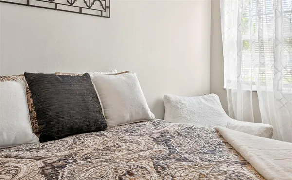 a bedroom with a bed and a couch
