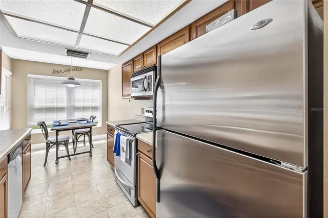 a kitchen with stainless steel appliances granite countertop a refrigerator and a stove