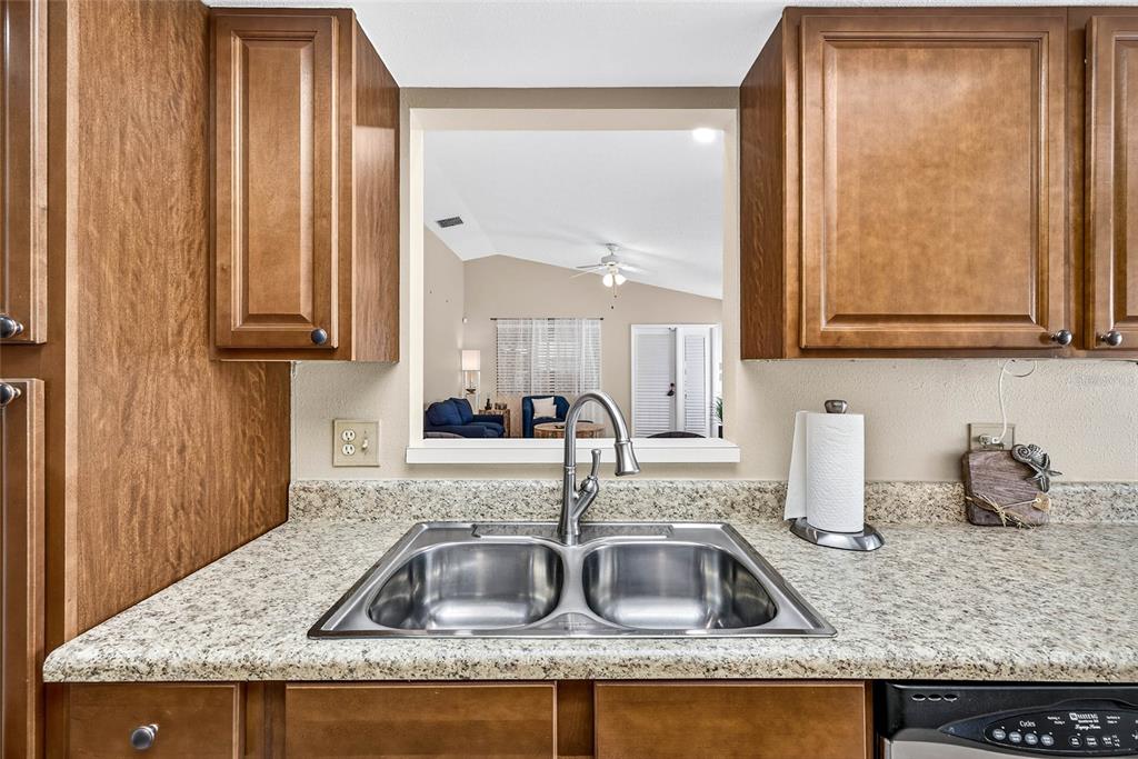 4658 Wallingford Court New Port Richey, FL 34655 - Photo 28 of 48 a kitchen with granite countertop a sink and a window