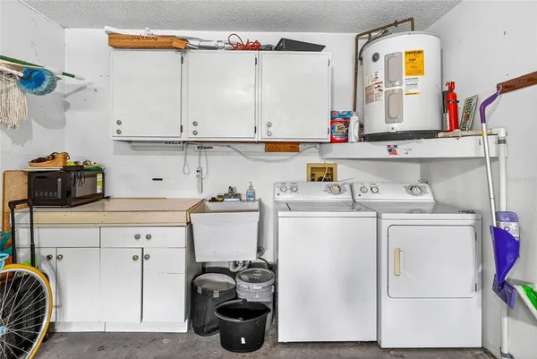 a utility room with sink dryer and washer