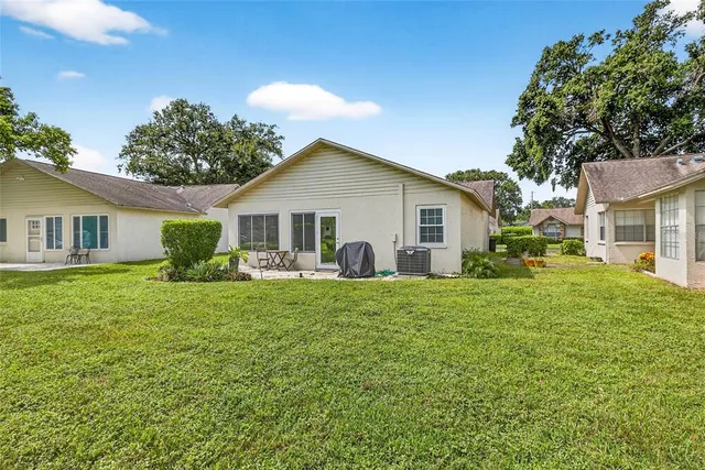 a view of a house with backyard and garden