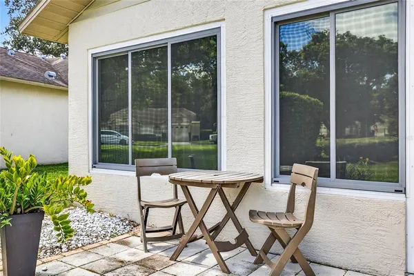 a building outdoor space with patio furniture and potted plants