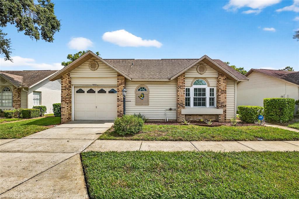 4658 Wallingford Court New Port Richey, FL 34655 - Photo 36 of 48 a front view of a house with a yard