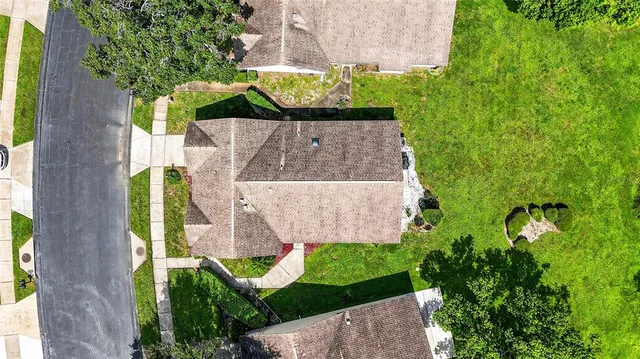an aerial view of a house with a garden