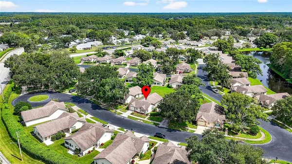 an aerial view of a house with a yard and lake view