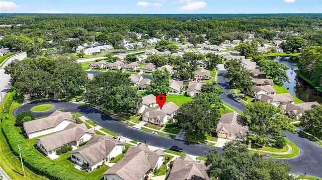 an aerial view of a house with a yard and lake view