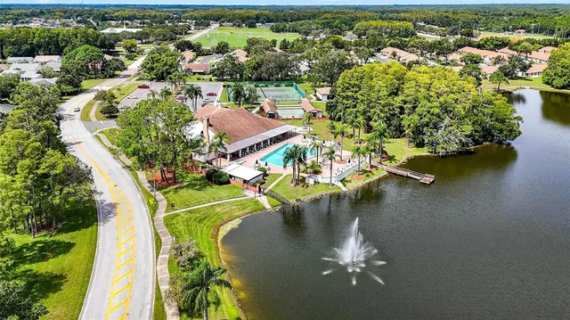 an aerial view of a house with a yard swimming pool outdoor seating and yard