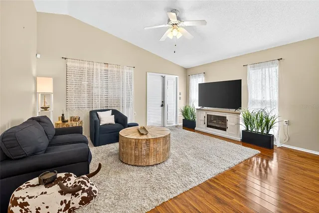 a living room with furniture a fireplace and a flat screen tv
