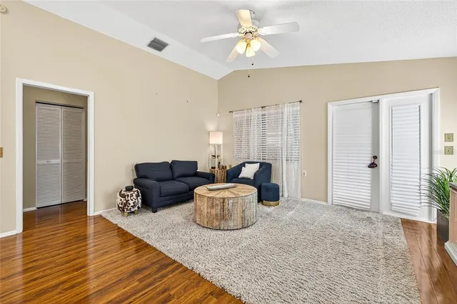 a living room with furniture and wooden floor