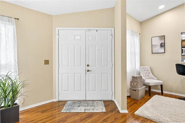 a view of a bedroom with wooden floor and bathroom