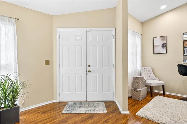 a view of a bedroom with wooden floor and bathroom