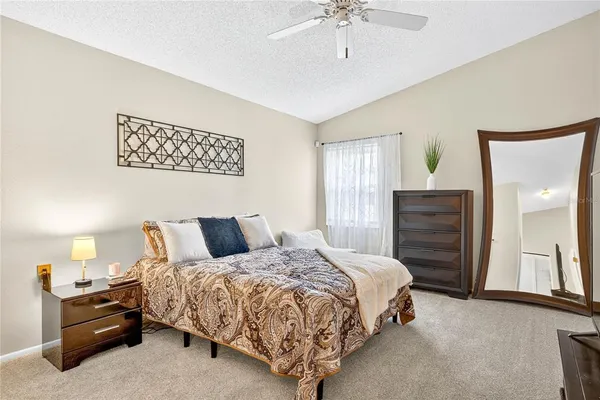 a bedroom with a bed and ceiling fan