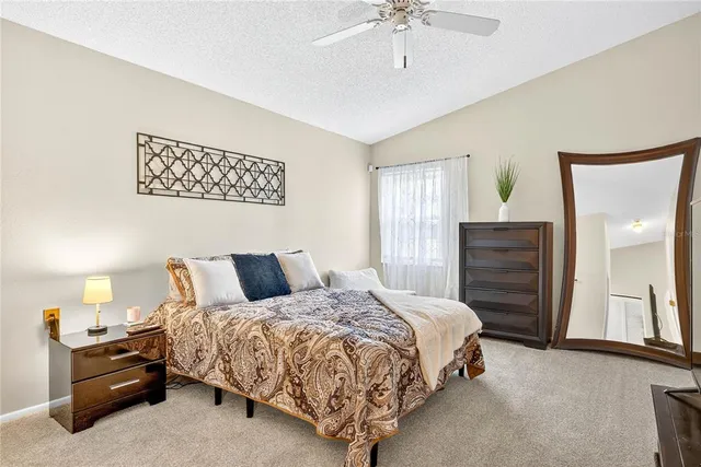 a bedroom with a bed and ceiling fan