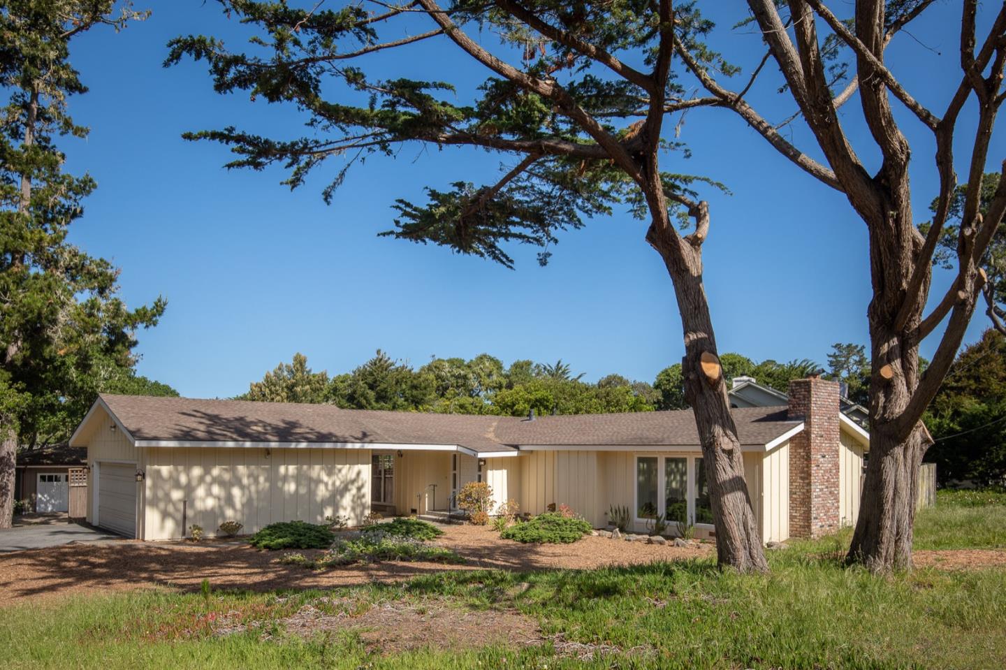 1043 Ocean Road Pebble Beach, CA 93953 - Photo 1 of 18 a front view of a house with garden