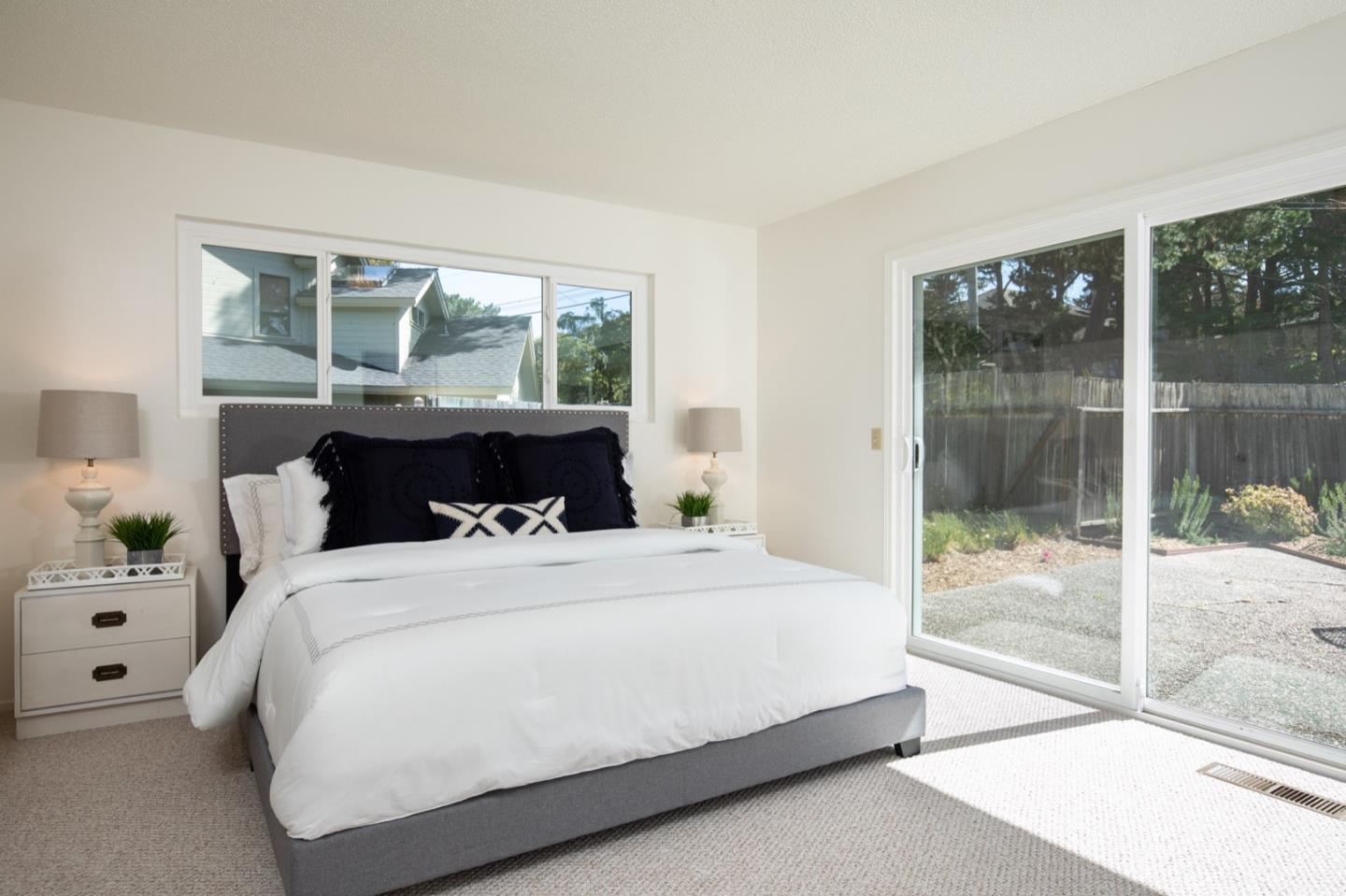 1043 Ocean Road Pebble Beach, CA 93953 - Photo 11 of 18 a bedroom with a bed and a large window