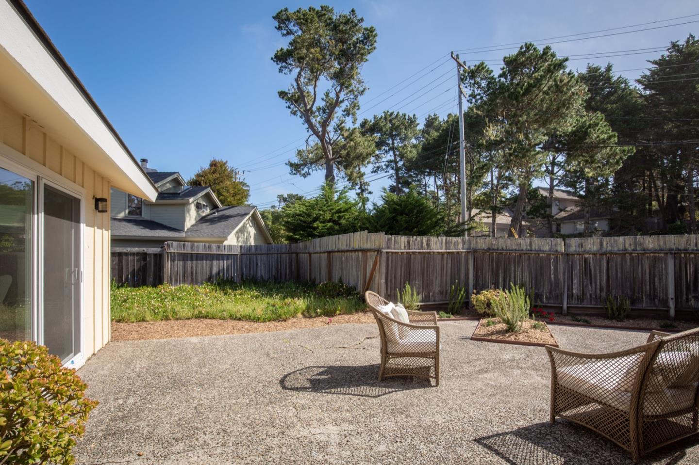 1043 Ocean Road Pebble Beach, CA 93953 - Photo 12 of 18 a view of a chairs in patio with wooden fence