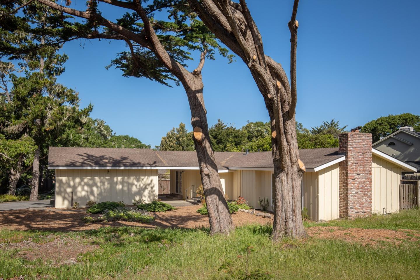 1043 Ocean Road Pebble Beach, CA 93953 - Photo 17 of 18 a front view of a house with garden