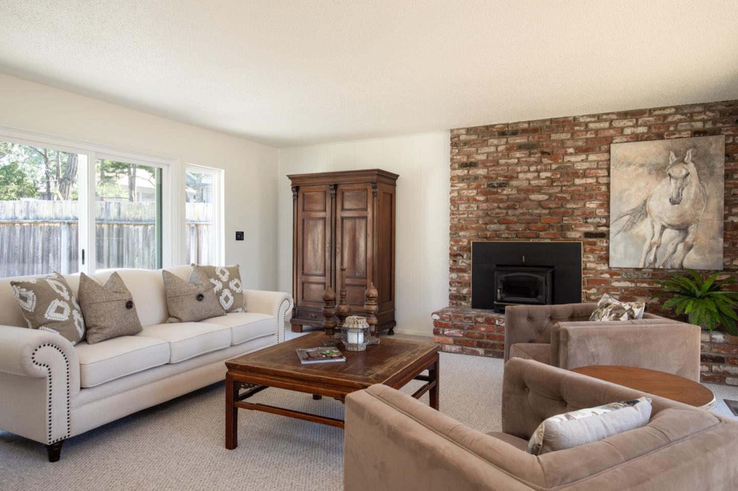 1043 Ocean Road Pebble Beach, CA 93953 - Photo 3 of 18 a living room with furniture and a fireplace