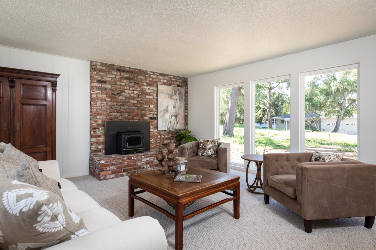 1043 Ocean Road Pebble Beach, CA 93953 - Photo 4 of 18 a living room with furniture and a fireplace