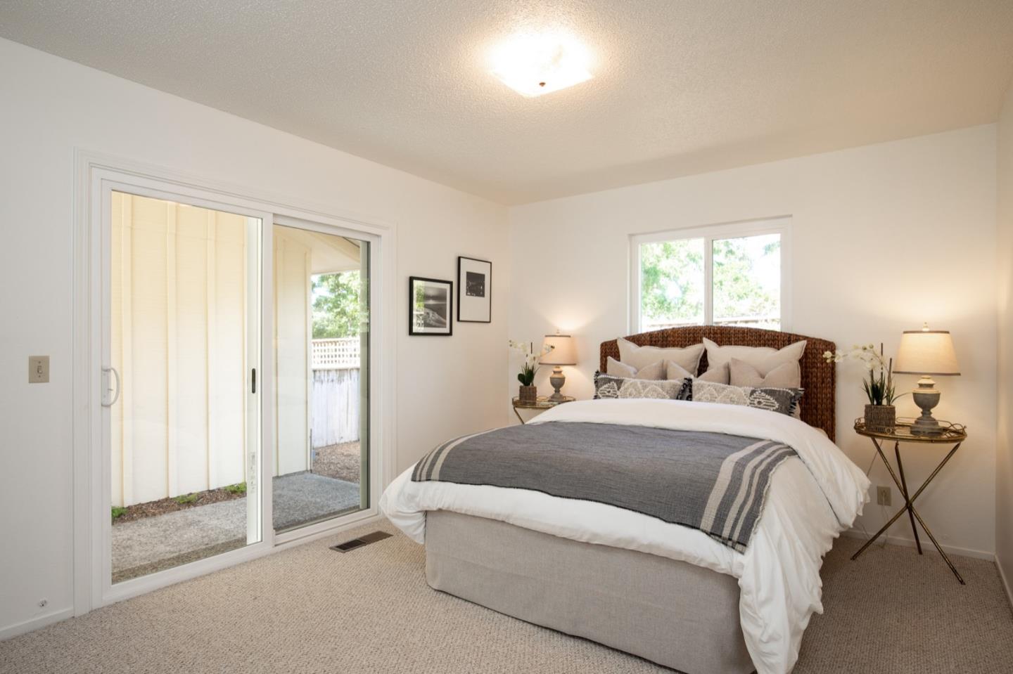 1043 Ocean Road Pebble Beach, CA 93953 - Photo 8 of 18 a bedroom with a bed and a window