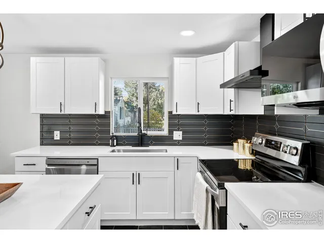 a kitchen with stainless steel appliances a sink and a stove