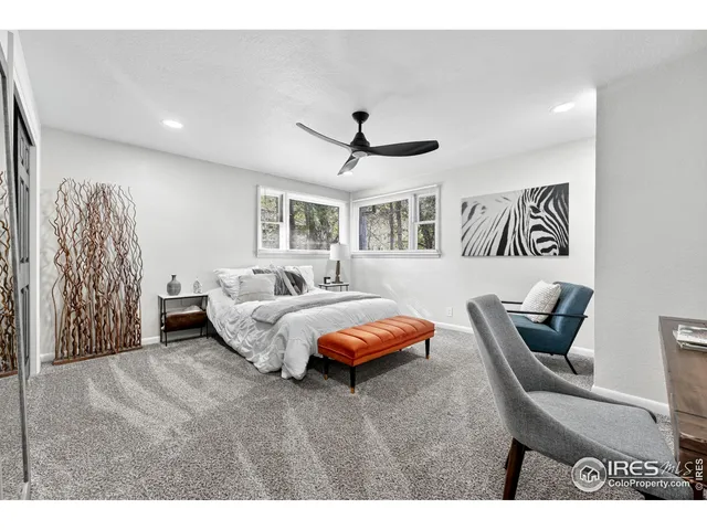 a spacious bedroom with a bed and a chandelier