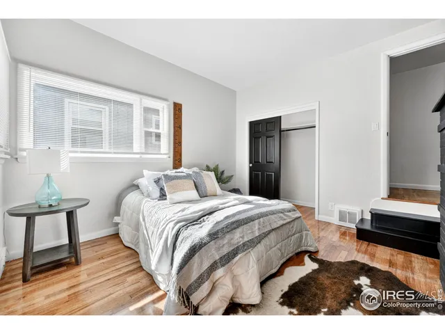 a bedroom with a bed and a mirror