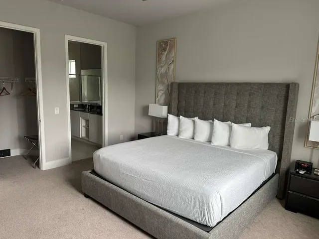 a bedroom with a bed and a large mirror