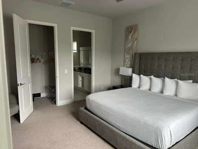 a bedroom with a bed and a sink