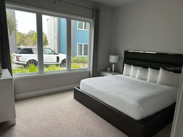 a bed sitting in a bedroom next to a window
