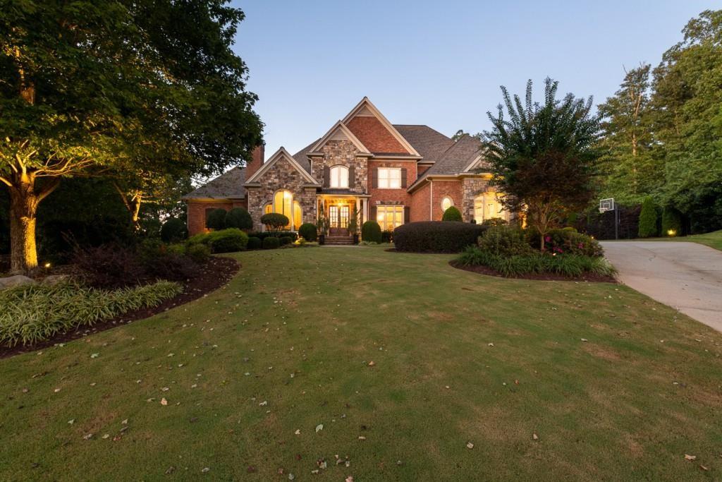 165 Autry Trail Alpharetta, GA 30022 - Photo 67 of 70 a front view of a house with a yard and garage