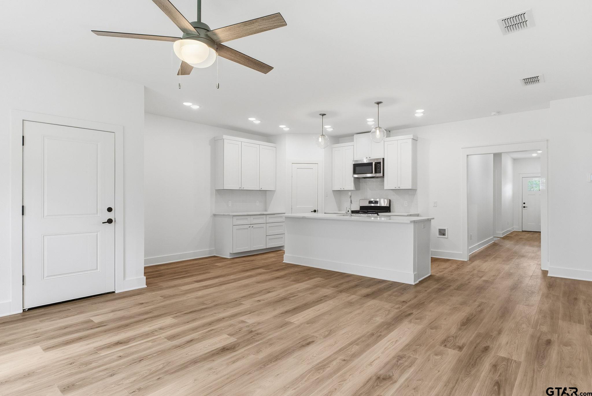 2968 Calloway Road Tyler, TX 75701 - Photo 6 of 24 a view of kitchen with wooden floor and window