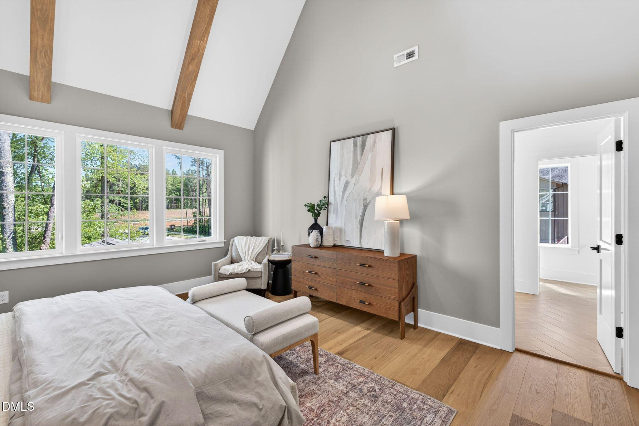 3340 Colby Chase Drive Apex, NC 27539 - Photo 34 of 80 a bedroom with a bed and wooden floor