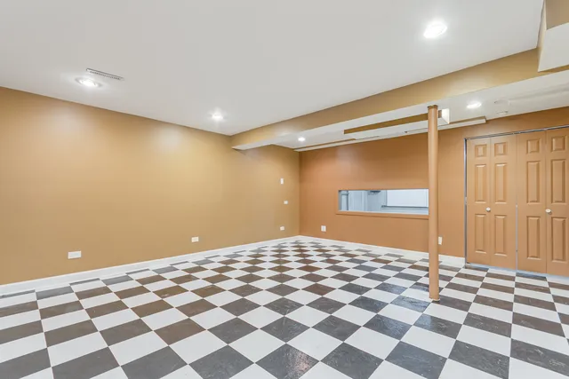 a bedroom with a black and white checkered floor