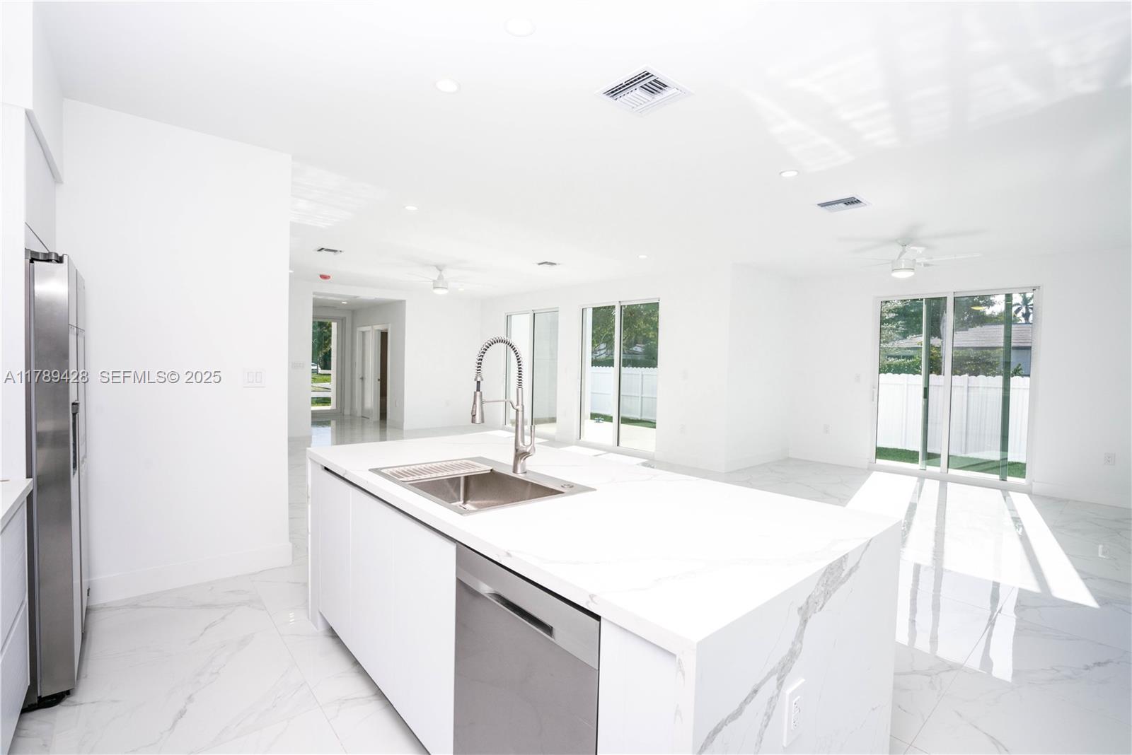 900 Southwest 24th Road Miami, FL 33129 - Photo 10 of 27 a kitchen that has a sink and a stove in it