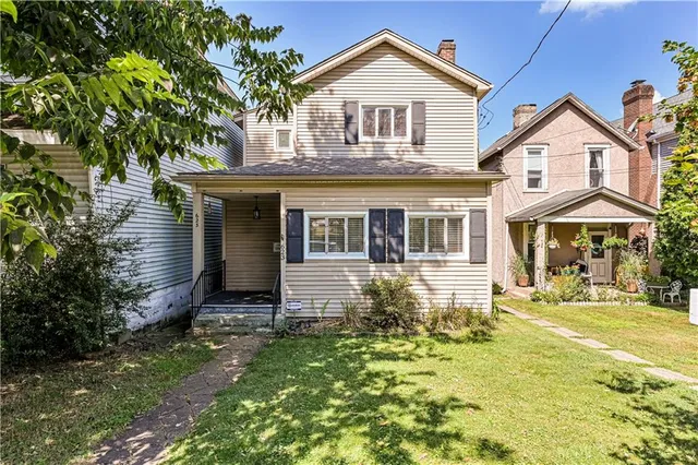 a front view of a house with a yard