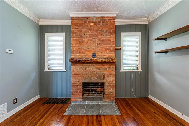a view of a kitchen with microwave and wooden floor