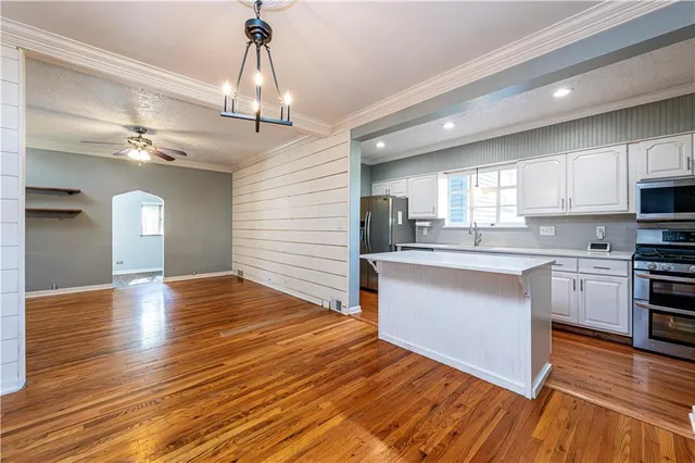 a view of a room with wooden floor and staircase