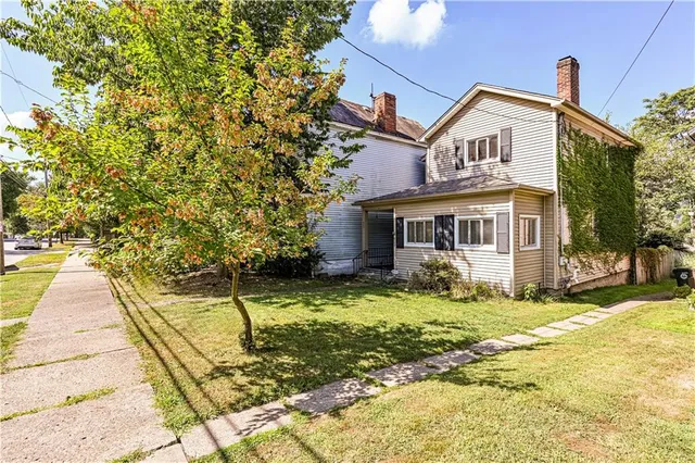 a front view of a house with a yard