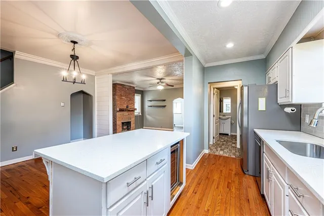 a large kitchen with kitchen island a sink a counter space and a window