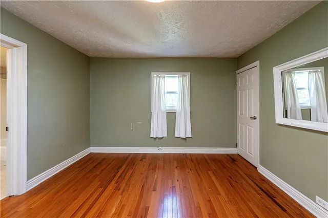 a view of a room with wooden floor and window